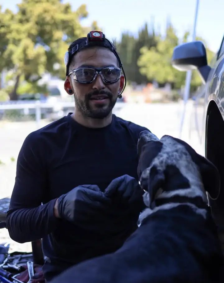 Francisco, owner of La Mesa Autoworks, working on a vehicle at the auto repair shop in La Mesa, California